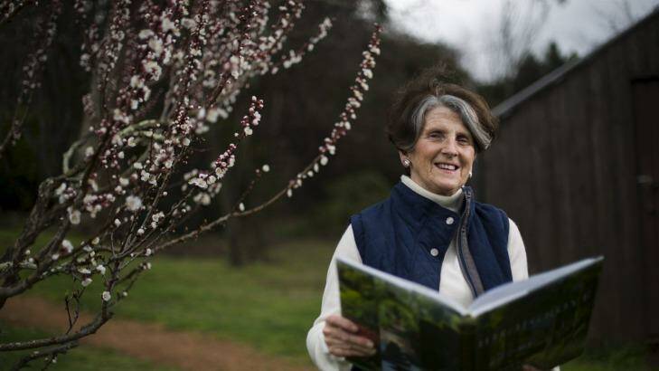 Let's do the thyme walk again: Danielle Hyndes in the orchard at Calthorpes' House in Red Hill perusing the <i>Highgrove: A Garden Celebrated</i>. Photo: Rohan Thomson