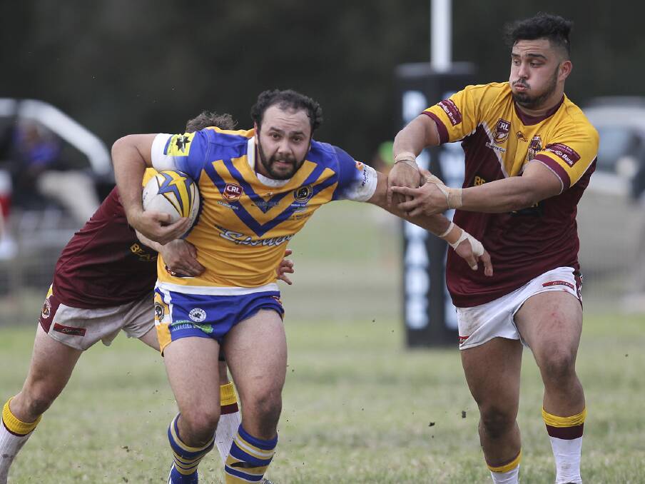 Warilla-Lake South Gorillas centre Tyson Brown tries to get clear of two Shellharbour City Sharks defenders during his side's 22-4 major semi-final win on Sunday. Picture: KIAMA PICTURE CO
