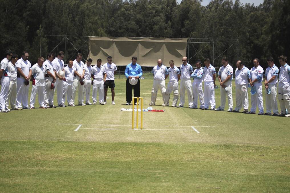Kookas and Oak Flats teams gather for a minute's silence in memory of the late Phillip Hughes on Saturday.Picture: DAVID HALLFirst grade.jpg