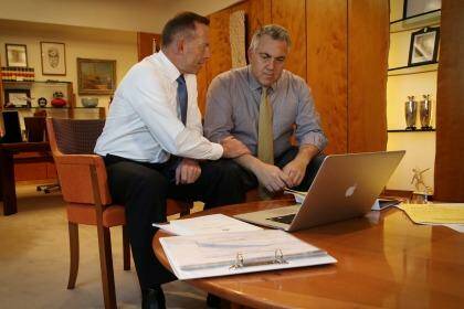 On Tuesday, Abbott and Hockey took part in a contrived photo opportunity pretending to go over drafts. Photo: Andrew Meares