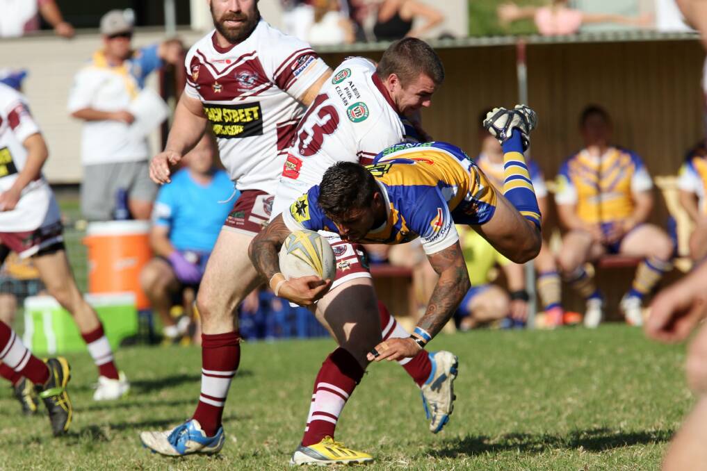 Warilla-Lake South Gorillas hooker Beau Sewell gets up-ended by Albion Park-Oak Flats lock Chris Rowles during the Gorillas' big win over the Eagles on Sunday. Picture: GREG TOTMAN