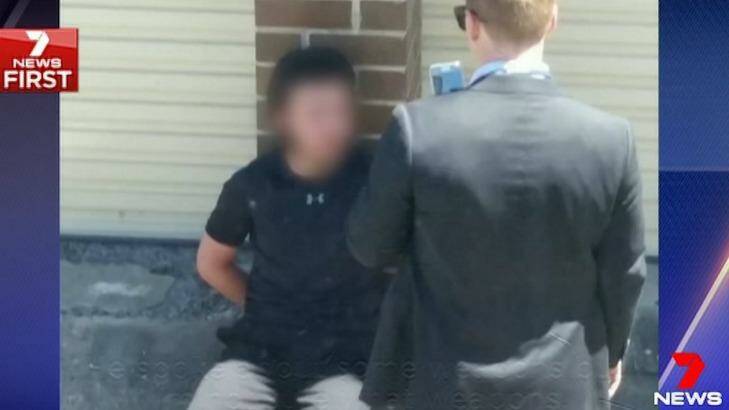 One of the 16-year-old boys, who cannot be identified for legal reasons, was filmed abusing police as he sat handcuffed in Adnum Lane on October 12. Photo: 7 News