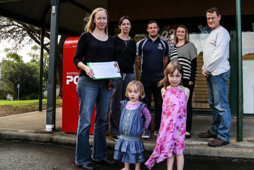 Natalie Allan, Michelle Voyer, Chris O'Hara, Julia O'Hara, Nick Hartgerink, Molly and Maeve Allan from the Save Kiama Downs from Petrol and Fast Food Giants action group support the launch of the petition against the proposal. Picture: GEORGIA MATTS