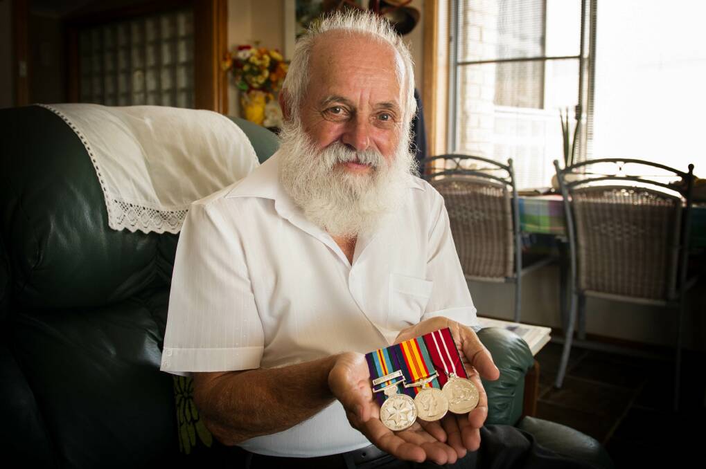 John Zarb proudly displays his medals. Picture: ALBEY BOND