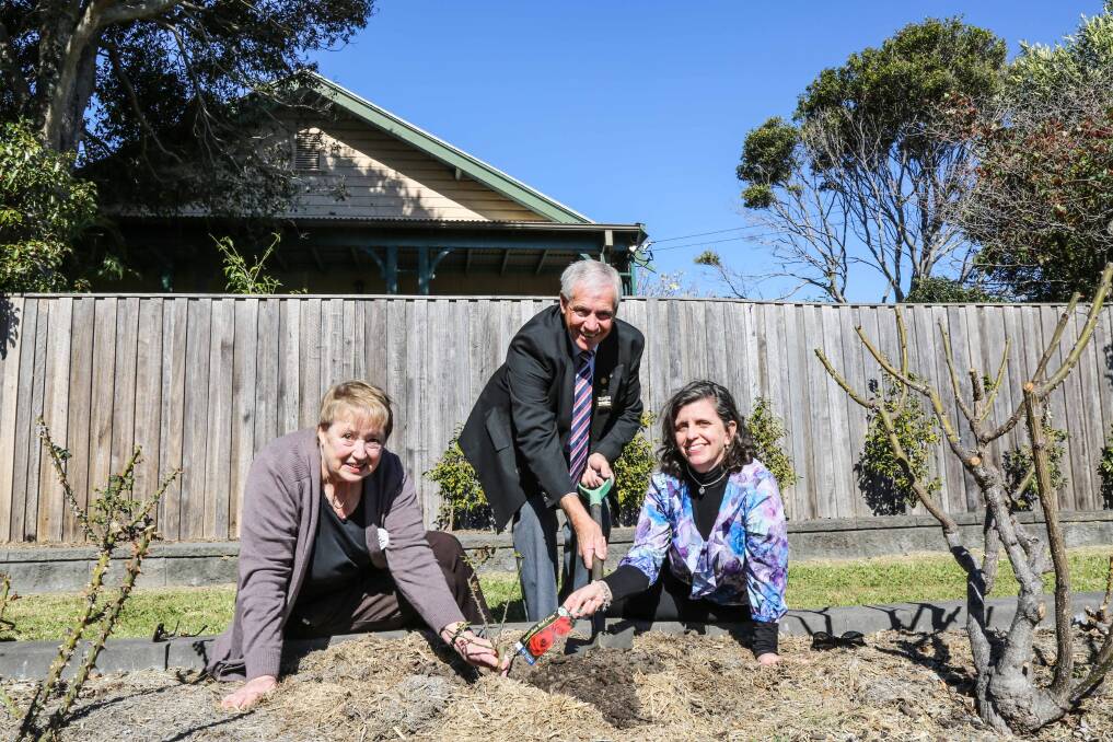 Kiama Red Cross president Anne Dowling, Mayor Bryan Petschler and the Kiama Red Cross vice president Heidi Smith planting a Red Cross Rose at Peace Park in Kiama, celebrating the Red Cross centenary. Picture: GEORGIA MATTS