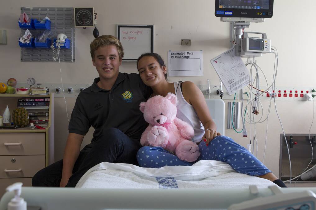 Emma Douglas, who collapsed during a soccer match when her heart stopped, with referee Max Vercoe who helped save her. Picture: CHRISTOPHER CHAN