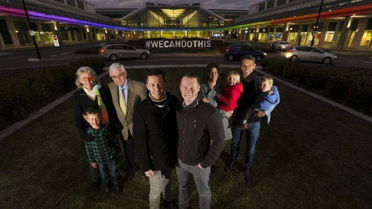 Tom Snow and husband Brooke Horne with members of the Snow family, who are supporters of gay marriage and have lit the terminal in support of the cause.  Photo: Graham Tidy