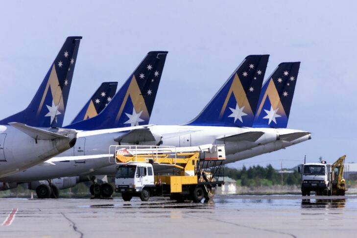 SPECIAL 001 bzc010914.001.003  Ansett.  For Age and SMH.  Picture by Bryan Charlton.  Ansett Collapse.  Adelaide.   Grounded Ansett planes blocked by heavy vehicles sit on the tarmac at Adelaide Airport.