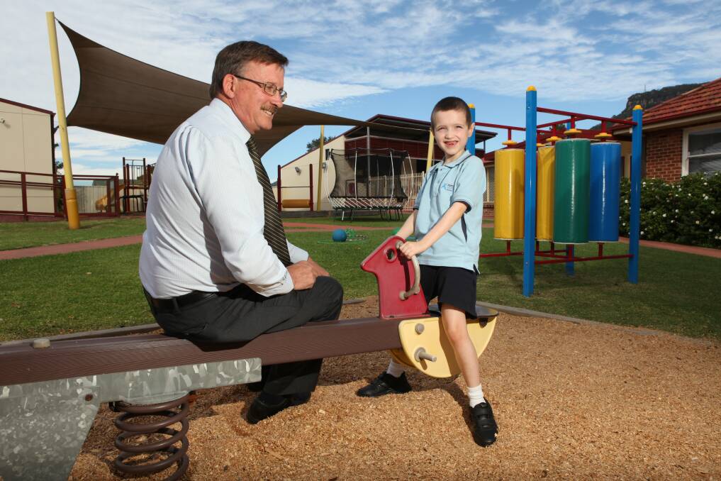 Aspect South Coast School principal Bruce Rowles with student Riley McConville last year. The school is raising funds to replace its Corrimal playground.