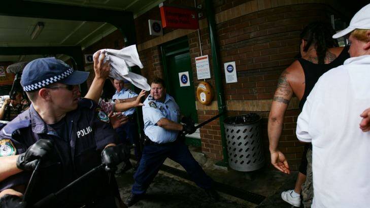 Craig Campbell, pictured with his baton, fends off violent youths during the Cronulla riots in 2005. Photo: Nick Moir