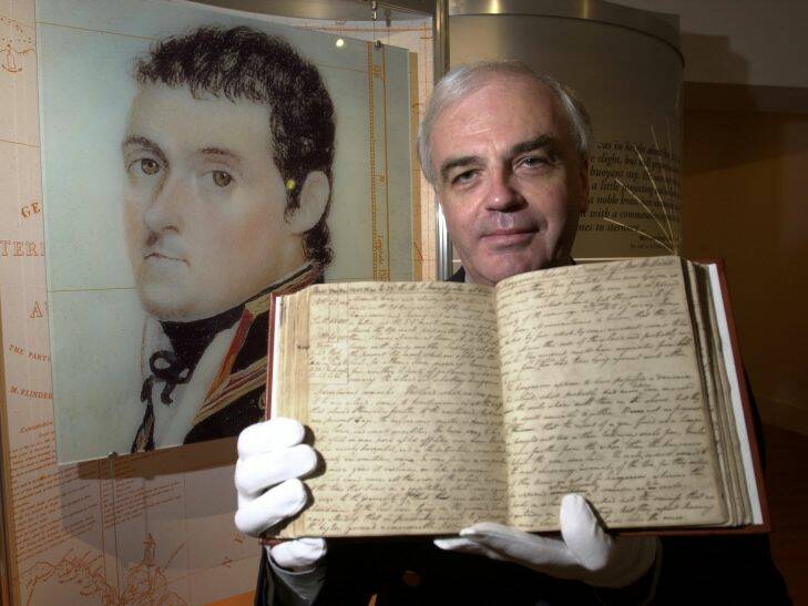 030320... Lannon Harley... News... Flinders- Curator of the national archives' Matthew Flinders exhibition, Paul Brunton holds up Flinder's original log on Thursday at The National Archives. Photo: Andrew Campbell