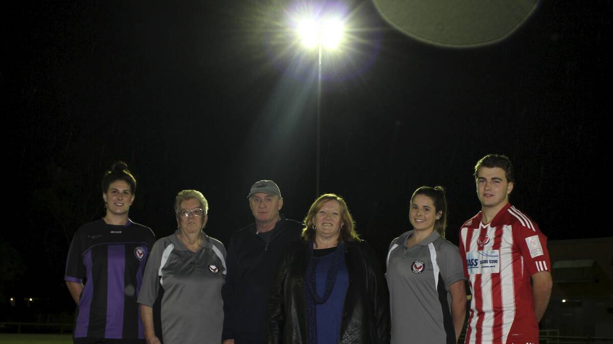 Long-time Oak Flats Falcons official Joan Hudson, Football South Coast's Tom Clark and Shellharbour Mayor Marianne Saliba with Falcons players Stephanie Jones, Rebecca Drew and Nathan McGovern at the official switching-on of the new lights at Keith Bond Oval for training and night games. Picture: DAVID HALL