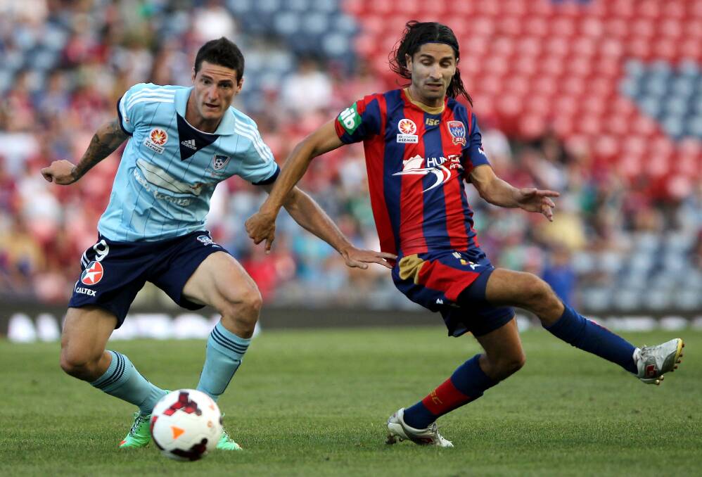 Sydney FC striker Corey Gameiro (left) in action against Jets player Zenon Caravella in the A-League in February. Picture: GETTY IMAGES