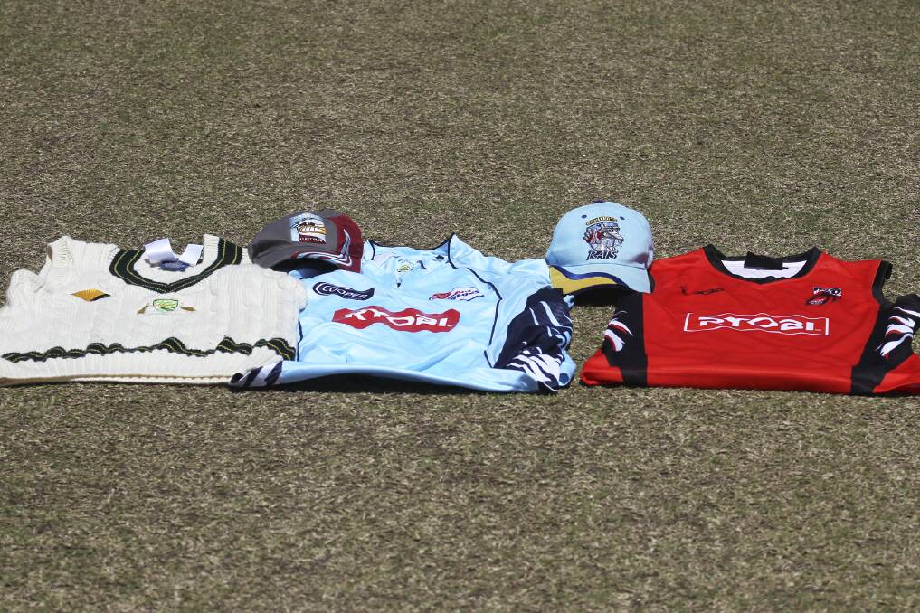Oak Flats and Warilla Kookas paid tribute to the late Phillip Hughes by laying out the three pullovers he represented, Australia, NSW and South Australia, on the pitch before Saturday's play. Picture: DAVID HALLJumpers.jpg