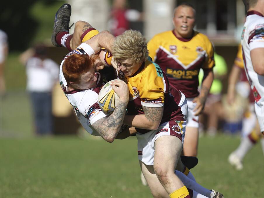 Albion Park-Oak Flats front-rower Shane Faricy is up-ended by a strong tackle from Shellharbour City lock Brad Chapman during the entertaining battle at Centenary Field on Sunday. Picture: DAVID HALL