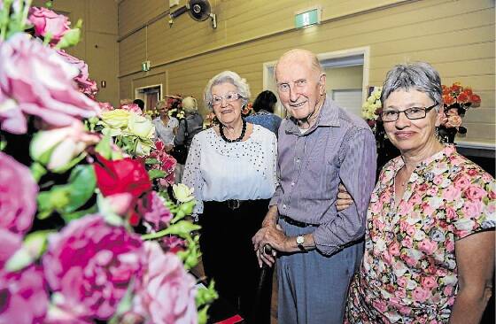The Illawarra Rose Society members Judy Daggar and Val Sutton with 40-year life member, John East. Picture: GEORGIA MATTS