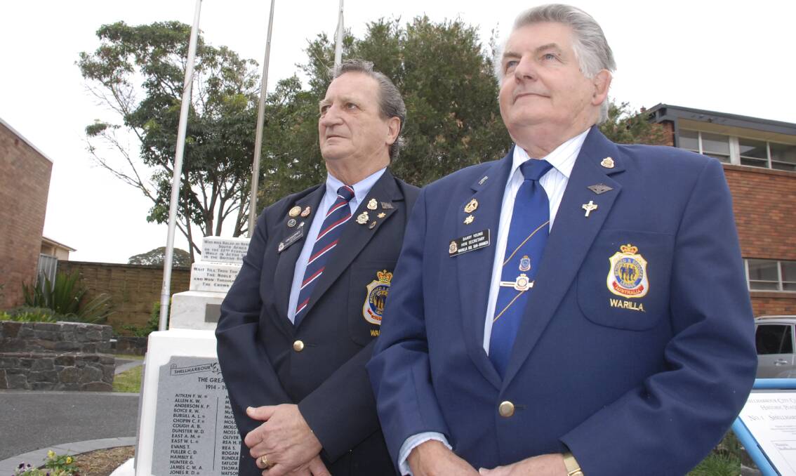 Warilla RSL Sub Branch president Kim Kearney and secretary Barry Young prepare for the Declaration of War commemoration at the Shellharbour War Memorial on August 4. Picture: ELIZA WINKLER