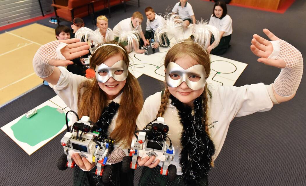 East Launceston grade 5 pupils Ella Hawkins and Imogen Pree stand in front of their fellow East Launceston team members with their dancing robots. Picture: SCOTT GELSTON