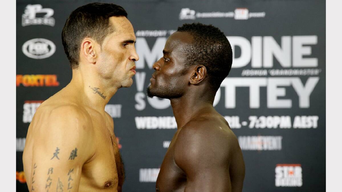 Anthony Mundine faces off with Joshua Clottey at the weigh-in at the Newcastle Entertainment Centre on Tuesday ahead of Wednesday's fight. Picture: Ryan Osland