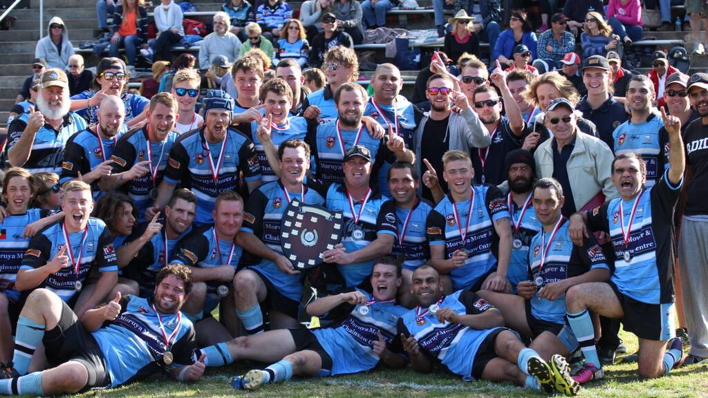 TROPHY TIME: Moruya Sharks reserve grade players, club committee members and supporters celebrate winning Group 16’s reserve grade premiership. 