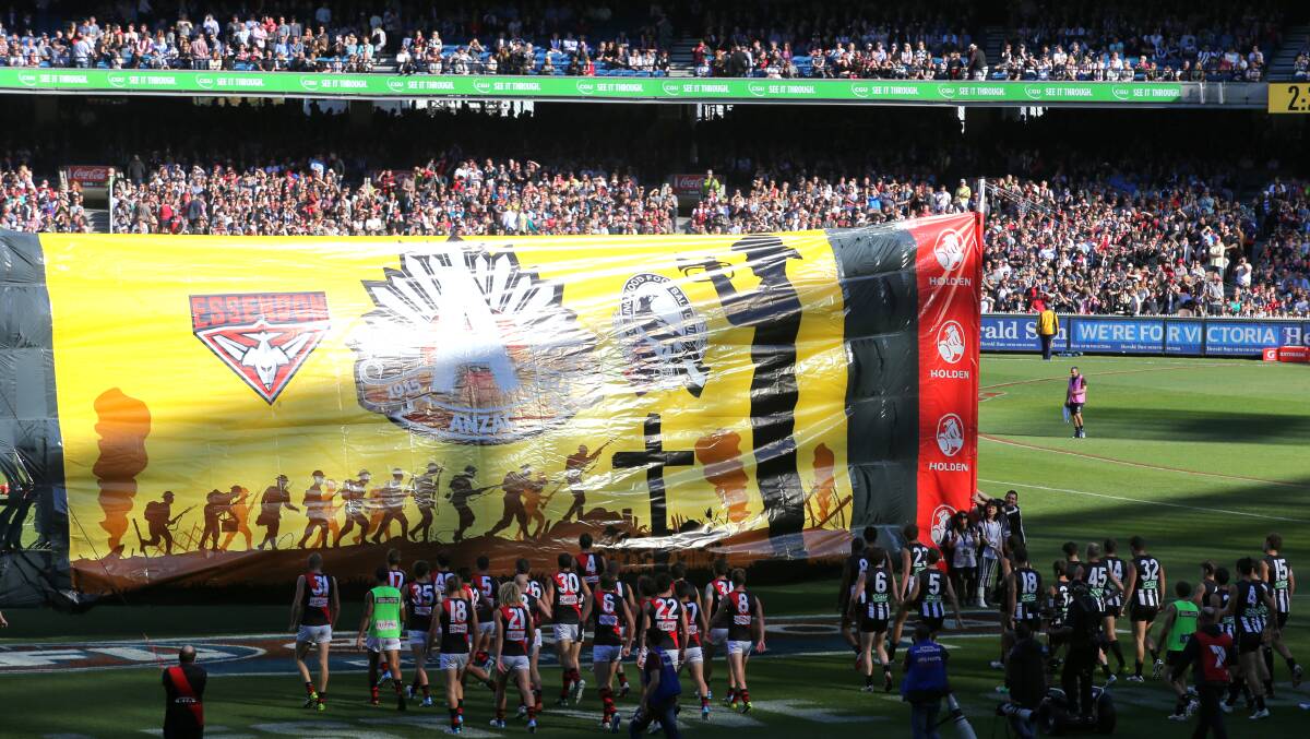 The teams run through the banner together before the game.Photo: Wayne Taylor, The Age. 