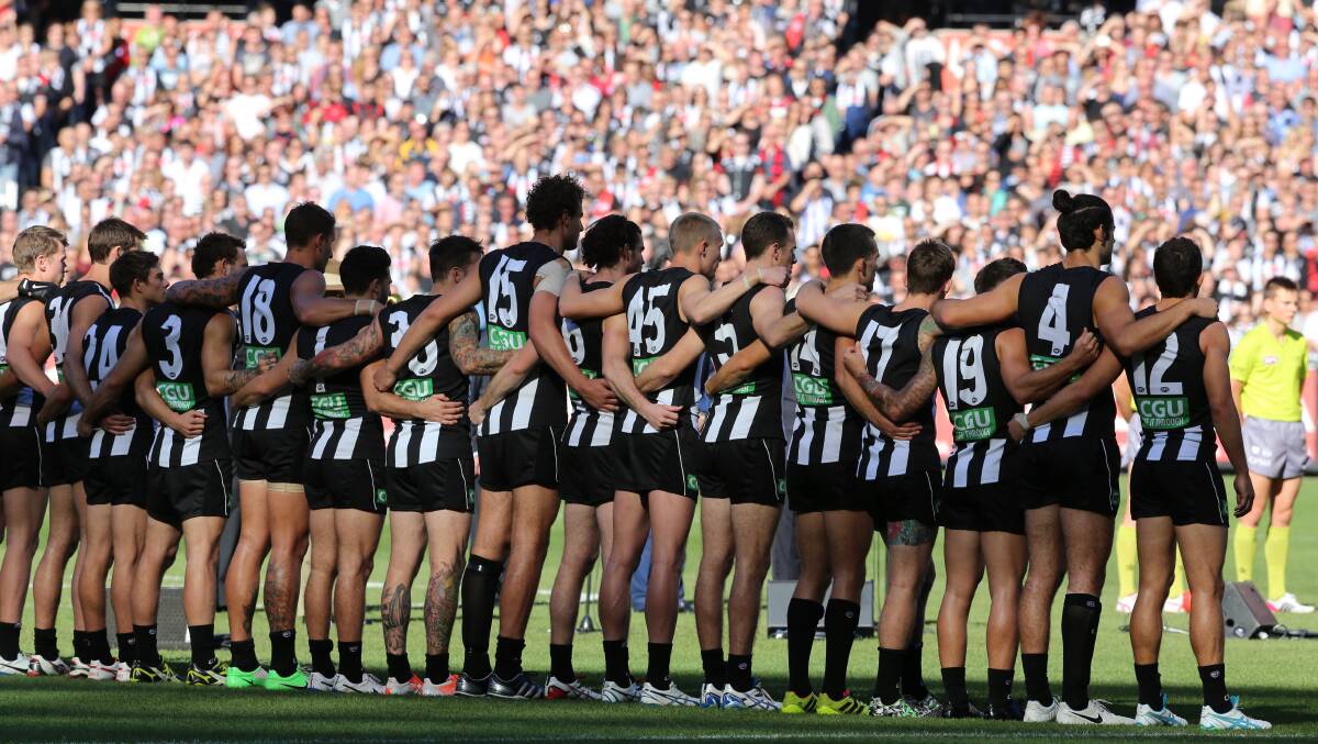 Teams line up for The Last Post and The National Anthem. Photo: Wayne Taylor, The Age. 