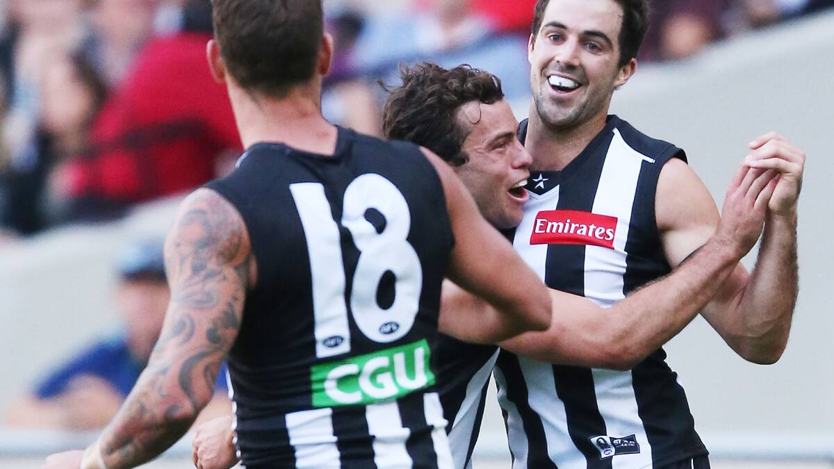 Steele Sidebottom (R) of the Magpies celebrates a goal with Jarryd Blair. Photo: Getty Images. 