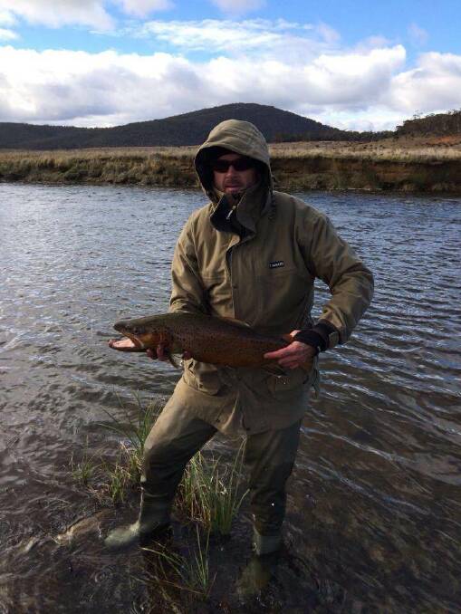 ANOTHER RELEASE: A fisher with a brown trout caught and released in the Eucumbene River. 