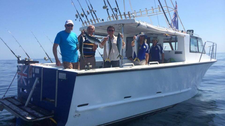 LIGHTHOUSE CHARTER: Skipper Warren "Wazza" Atkinson and his happy clients at Montague Island on Saturday morning with their kingfish haul.  (5/2/14)