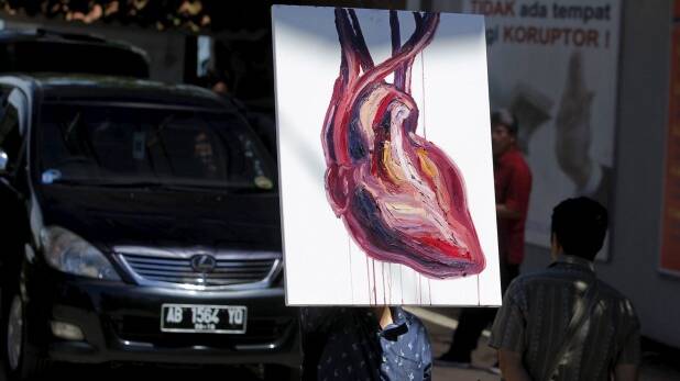 A man holds the heart painting by Sukumaran after visiting the prison island of Nusakambangan. Photo: Reuters