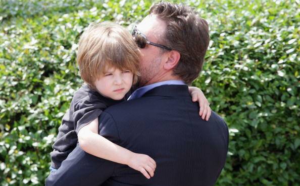 Tennyson Crowe finds a safe place in the arms of father Russell Crowe.