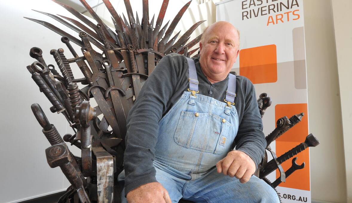 WINTER IS HERE: Urana sculptor Andrew Whitehead assumes a position of power as he sits in the iron throne. Picture: Laura Hardwick