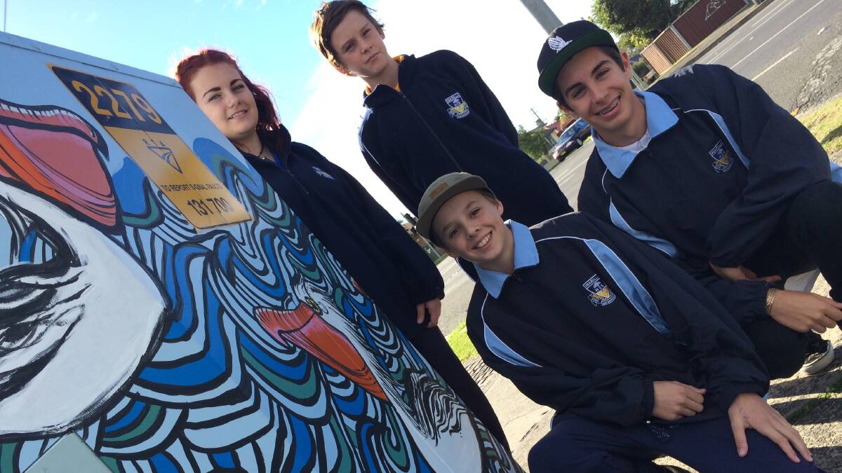 Warilla High School students, Hayden Shoobridge, Emma Nau, Lachie Gromek and Brendan Muscat, celebrate their street art for the Telstra box project . Picture Eliza Winkler