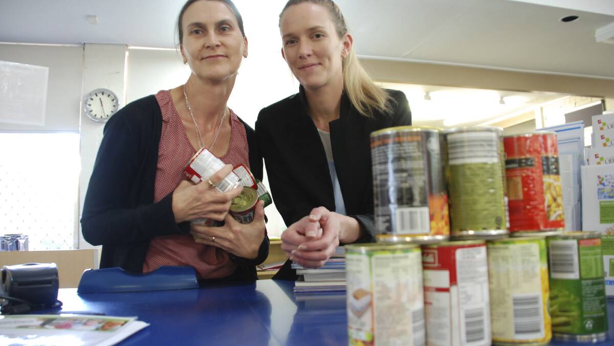 Lisa Zanetti and Erin Tierney of Warilla Library are swapping outstanding library fees for food. Picture Eliza Winkler