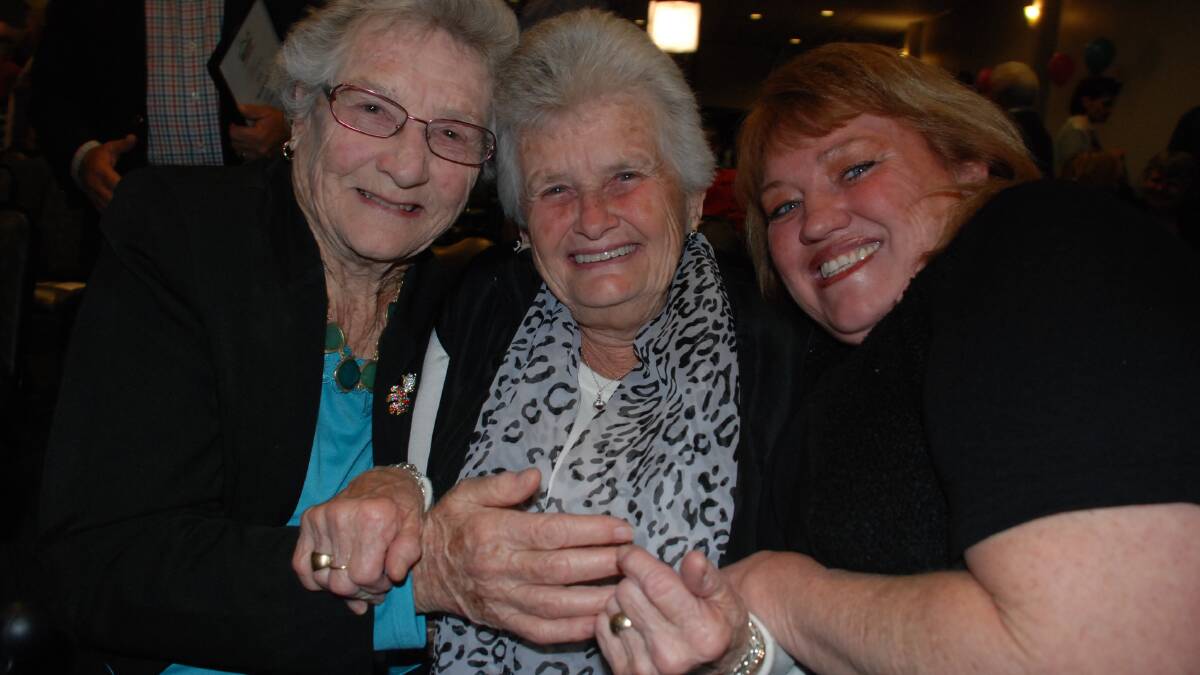 Chuffed Isobel Williams sits with her neighbour and best friend Lorna Barrett and daughter Heather Campomar at the 2014 Neighbour Award night at Shellharbour Wrokers Club. Picture Eliza Winkler