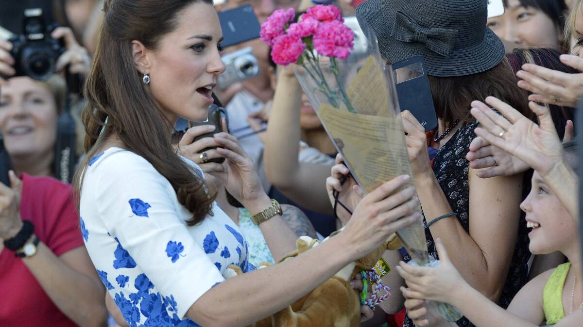 Catherine, Duchess of Cambridge is given flowers by a young girl in Brisbane.  (Photo by Bradley Kanaris/Getty Images)