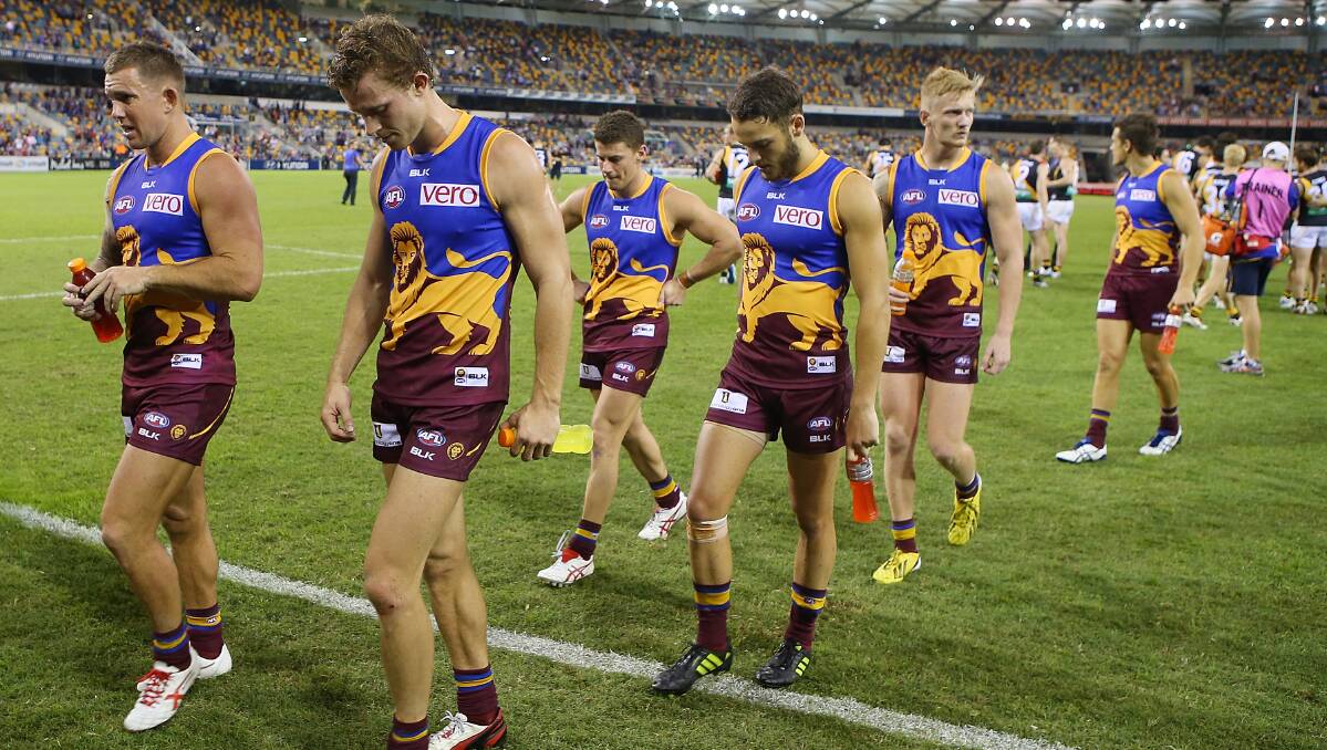 Brent Moloney and Ryan Lester of the Lions leave the field after losing the round five AFL match between the Brisbane Lions and the Richmond Tigers at The Gabba on April 17, 2014 in Brisbane, Australia. Photo: Chris Hyde/Getty Images.