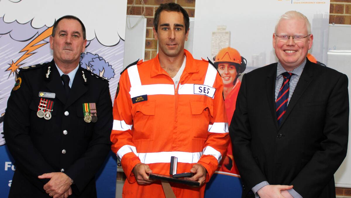 Kiama SES member Daniel Vrckovski received a 15-year appreciation certificate from NSW SES Acting Commissioner Jim Smith and Member for Kiama Gareth Ward. Picture: DAVID HALL