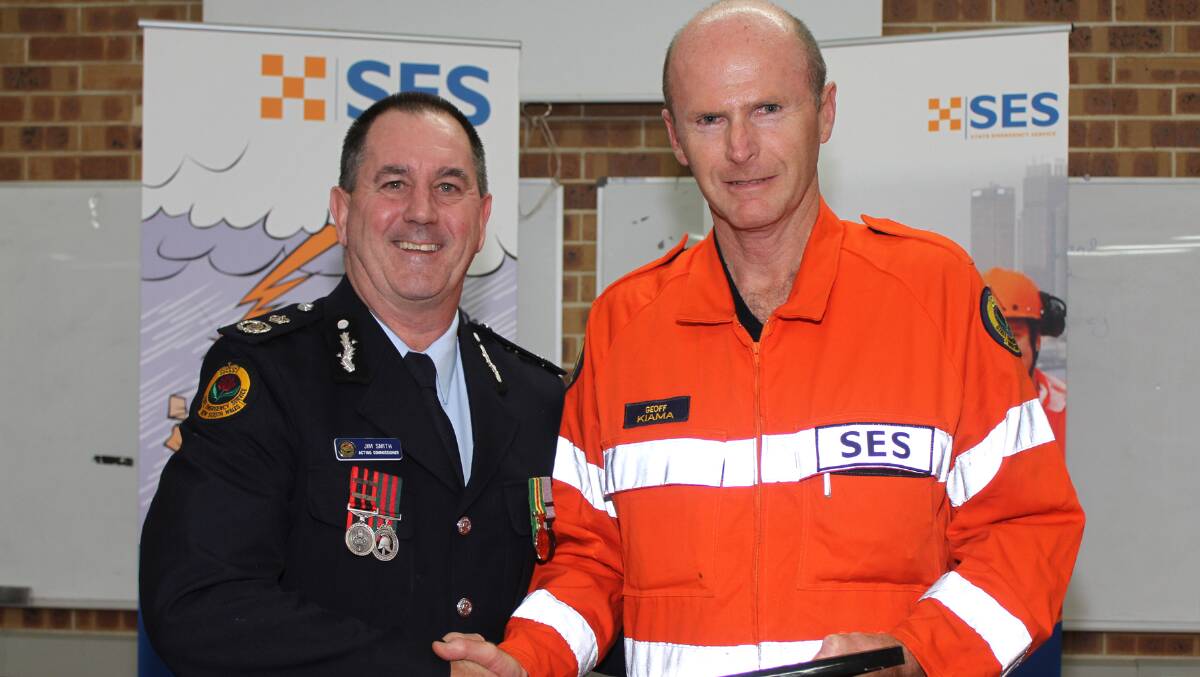 Geoff Cornwell accepting his 10 year certificate form Acting Commissioner of NSW SES Jim Smith. Picture: DAVID HALL