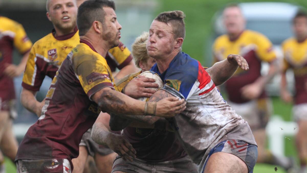 KIAMA INDEPENDENT: Returning Gerringong lock Kal Collins tries to get away from two Shellharbour defenders during Sunday’s clash at Ron Costello Oval. PICTURE: DAVID HALL