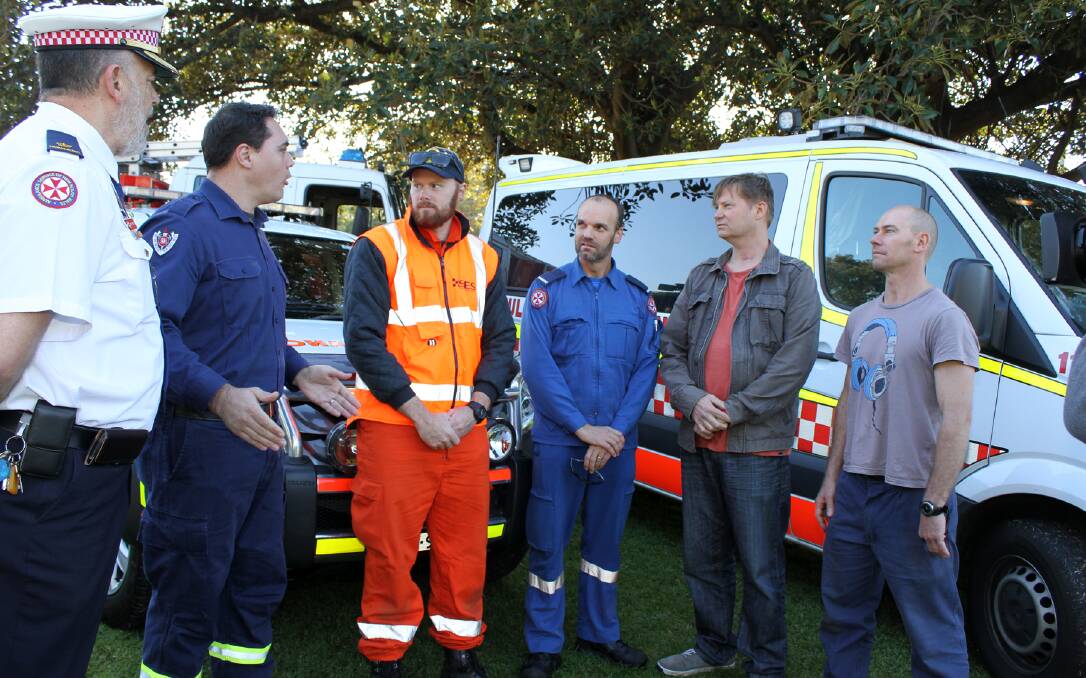 Darryl Leslie (second from right) chats with rescuers Inspector Norm Rees, Robert Schilder from Kiama Fire and Rescue, Rob McDonald from Kiama SES, paramedic David Kay and his mate Alex Henricson on Tuesday. Picture: DAVID HALL