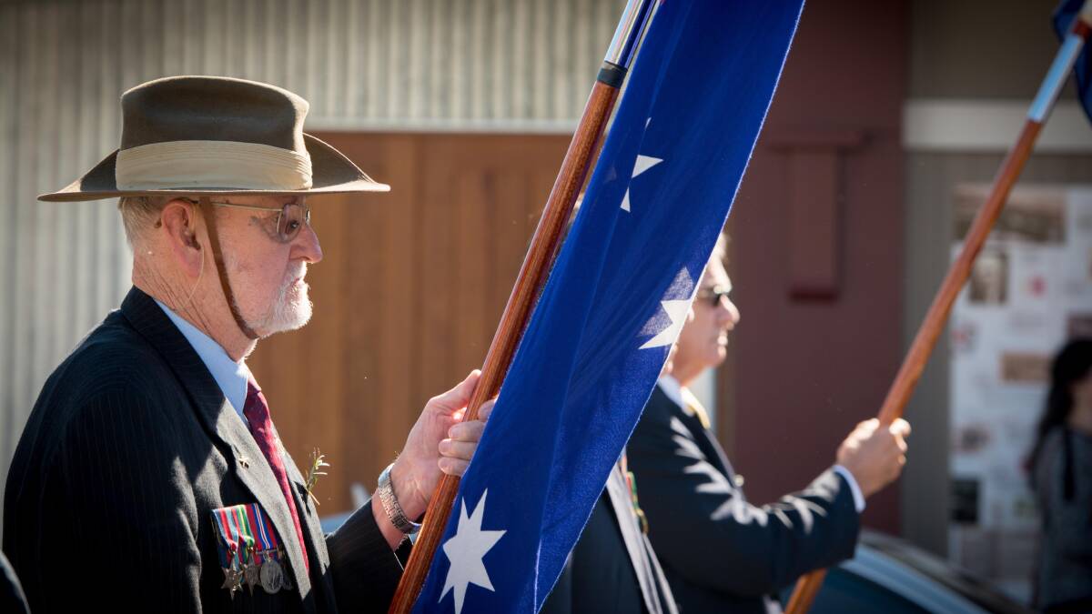 John Kearns proudly holds the Australian flag.