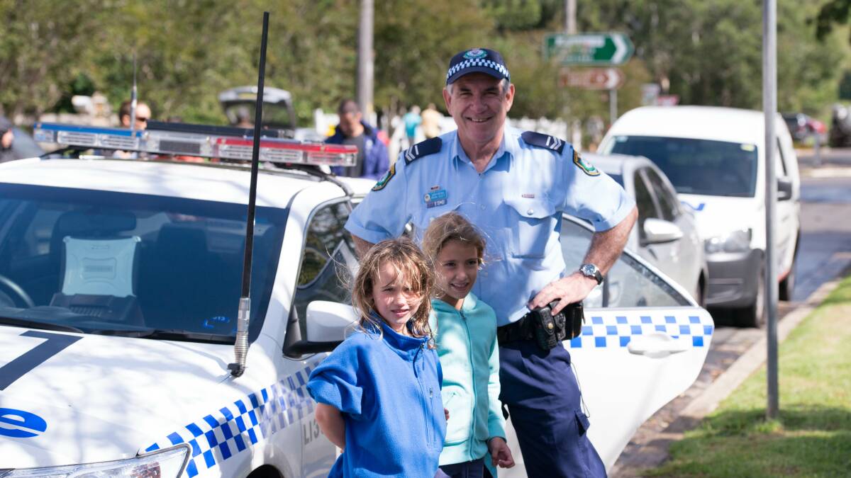 Bonnie Starling and Suraya Philp-Rudd with Lake Illawarra Local Area Command's Senior Constable Mark Scott at Saturday's street parade.