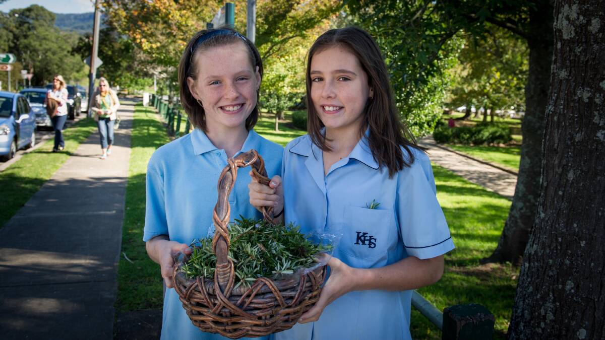 Renee Weir (Jamberoo Public School) and Erin Weir (Kiama High School) with sprigs of rosemary that were handed out on Saturday. 