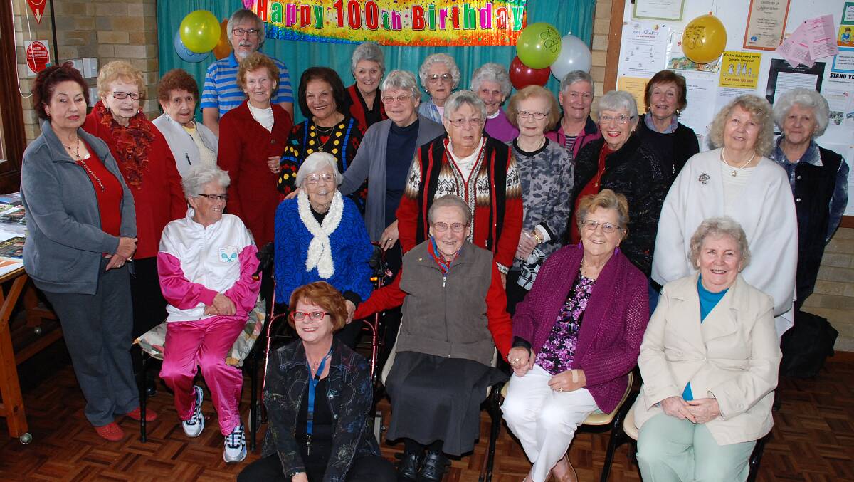 Members of the Kiama Adult Care Friday Friends gathered to wish Lilian Wood (second from left seated) a happy 100th birthday. Picture: DAVID HALL