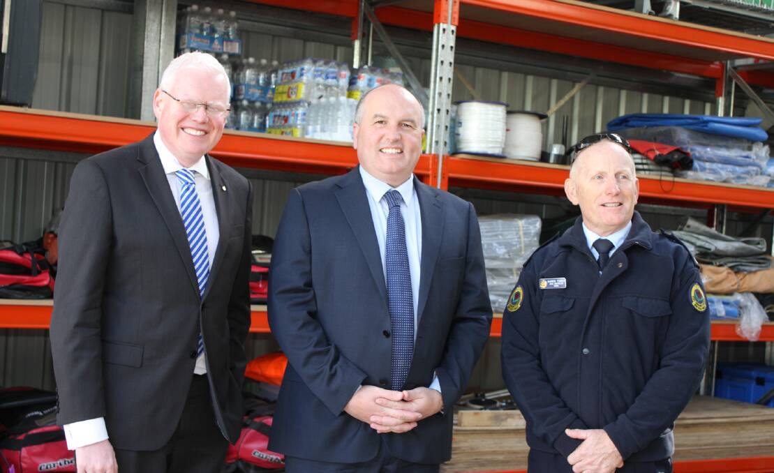 Member for Kiama, Gareth Ward, NSW Minister for Emergency Services David Elliott and Kiama SES Controller Warren Turner inside the new gear shed. Picture: DAVID HALL