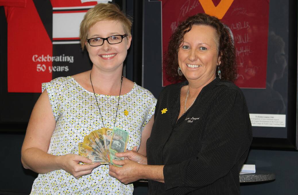 Cancer Council representative Jennifer Menchin accepts the proceeds of the recent Australia's Biggest Morning Tea from Kiama Leagues Club's Sharyn Tester. Picture: DAVID HALL
