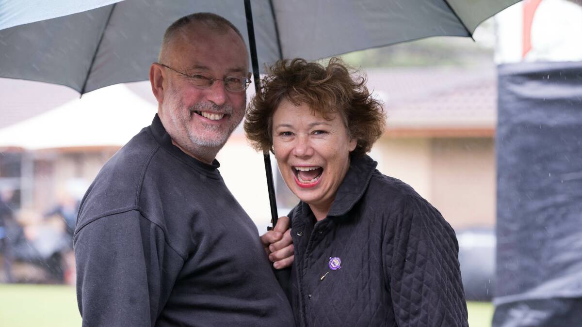 Bill and Robyn Sharpe didn't let the rain ruin their day out. Picture: ALBEY BOND