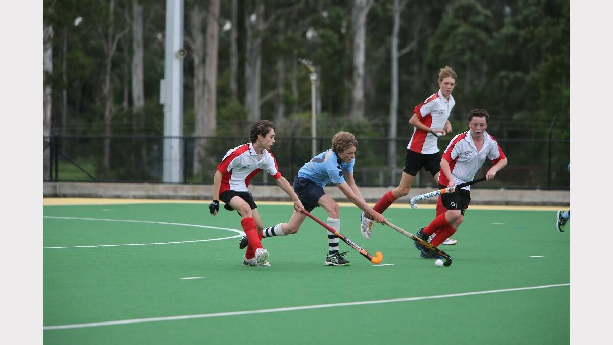 SHOALHAVEN: St Georges Basin’s Josh Rickwood tries his best to stop Bluejays’ Danny Ball on Saturday in the Shoalhaven Hockey Competition. 
