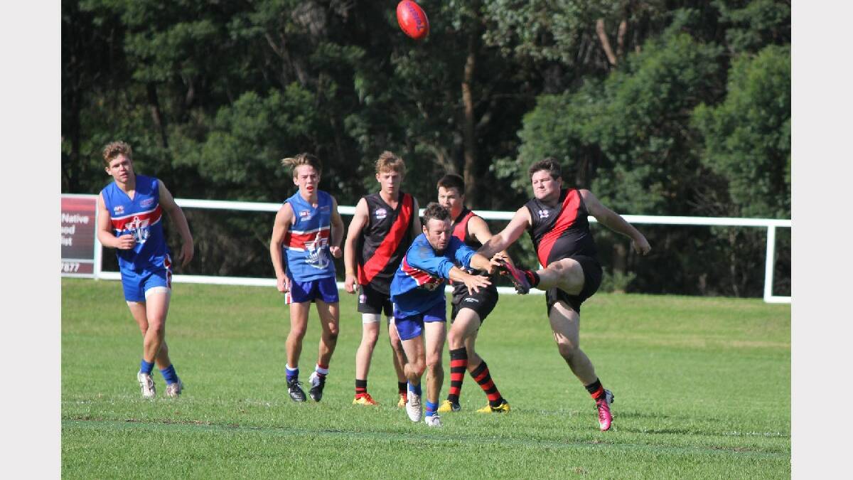 BEGA: Bega Bombers coach Matt Fleet (right) clears the ball with a big left boot against the Merimbula Diggers on Saturday.